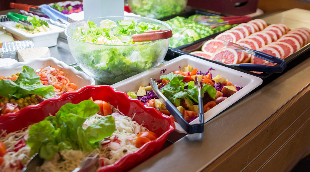 A large help-yourself salad bar showing grapefruit slices, grated raw cabbage and typical salad leaves